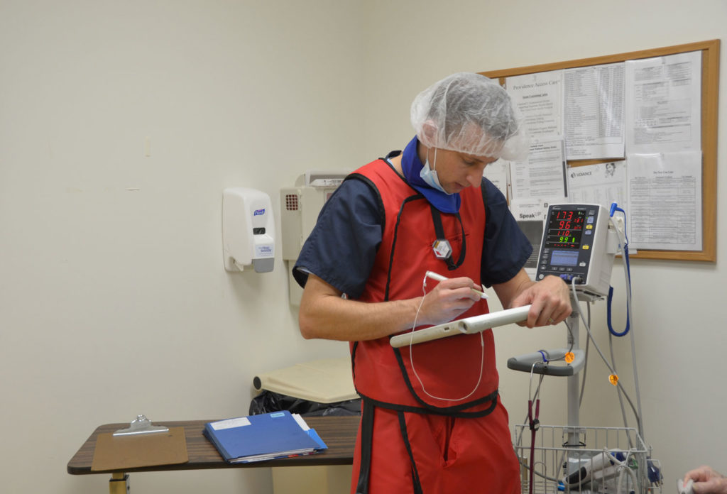 Image of a Doctor using a device at, Providence Access Care