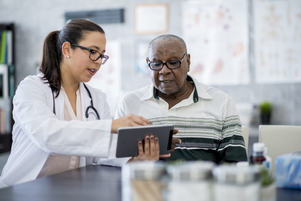 Senior PAD patient talking to doctor