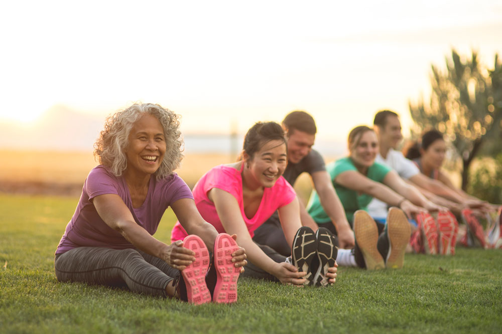 women stretching their legs to prevent varicose veins