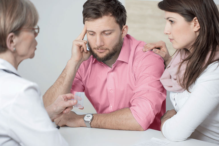 Young Couple Consulting Doctor About Cause of Infertility