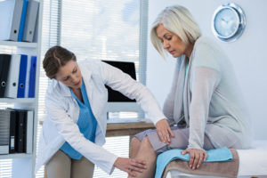 woman getting varicose veins inspected