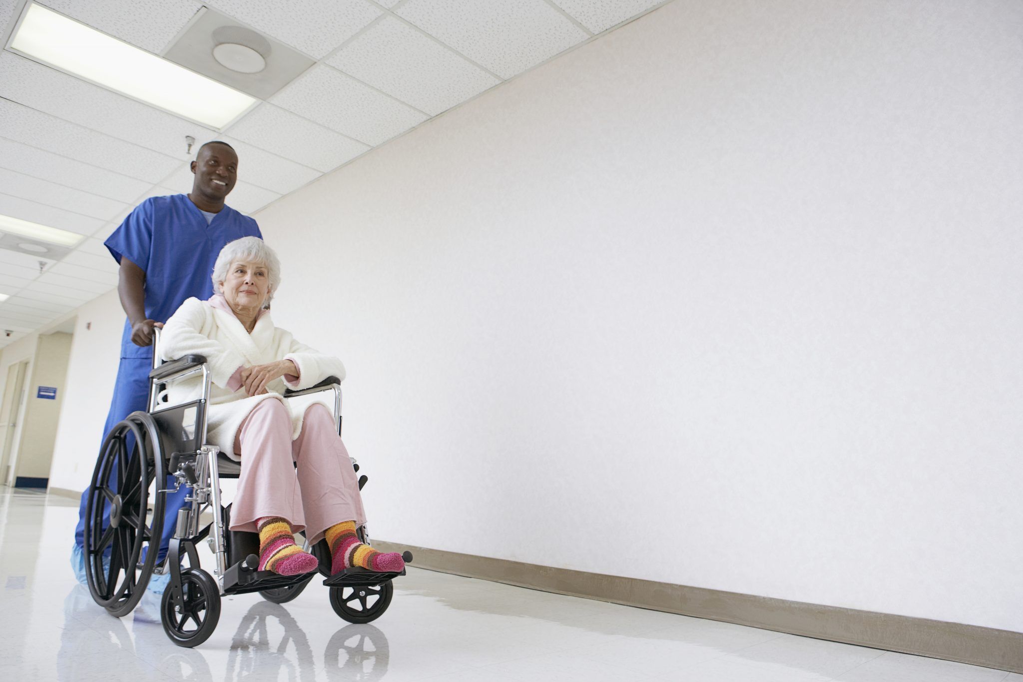 Nurse pushing patient in a wheelchair