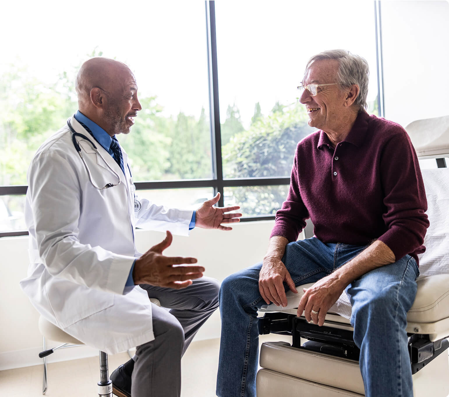A man discussing varicocele embolization with his doctor.